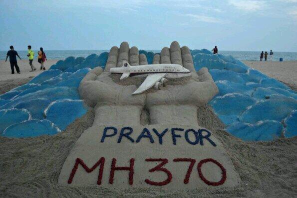 Sand Sculpture of Malaysia Airplane in God's Hands
